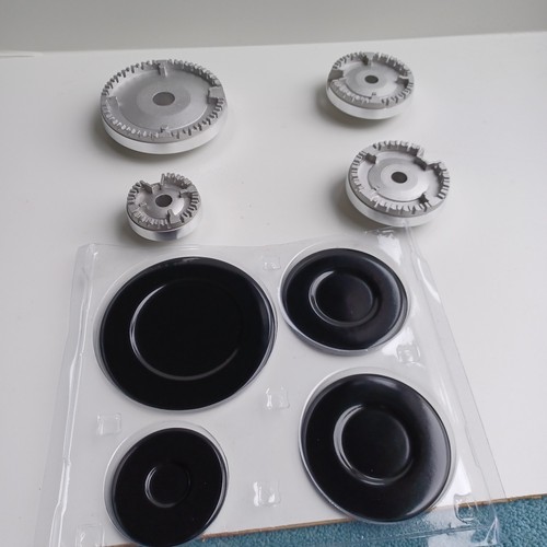 Four black burner lids and - lids,